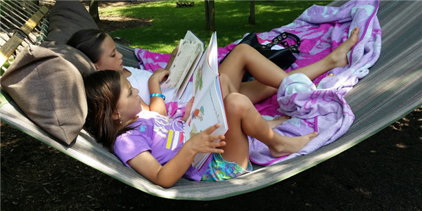 girls reading on hammock girls reading on hammock